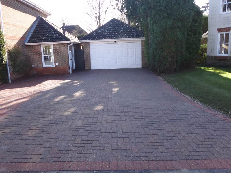 Blue and red block paving leading to garage