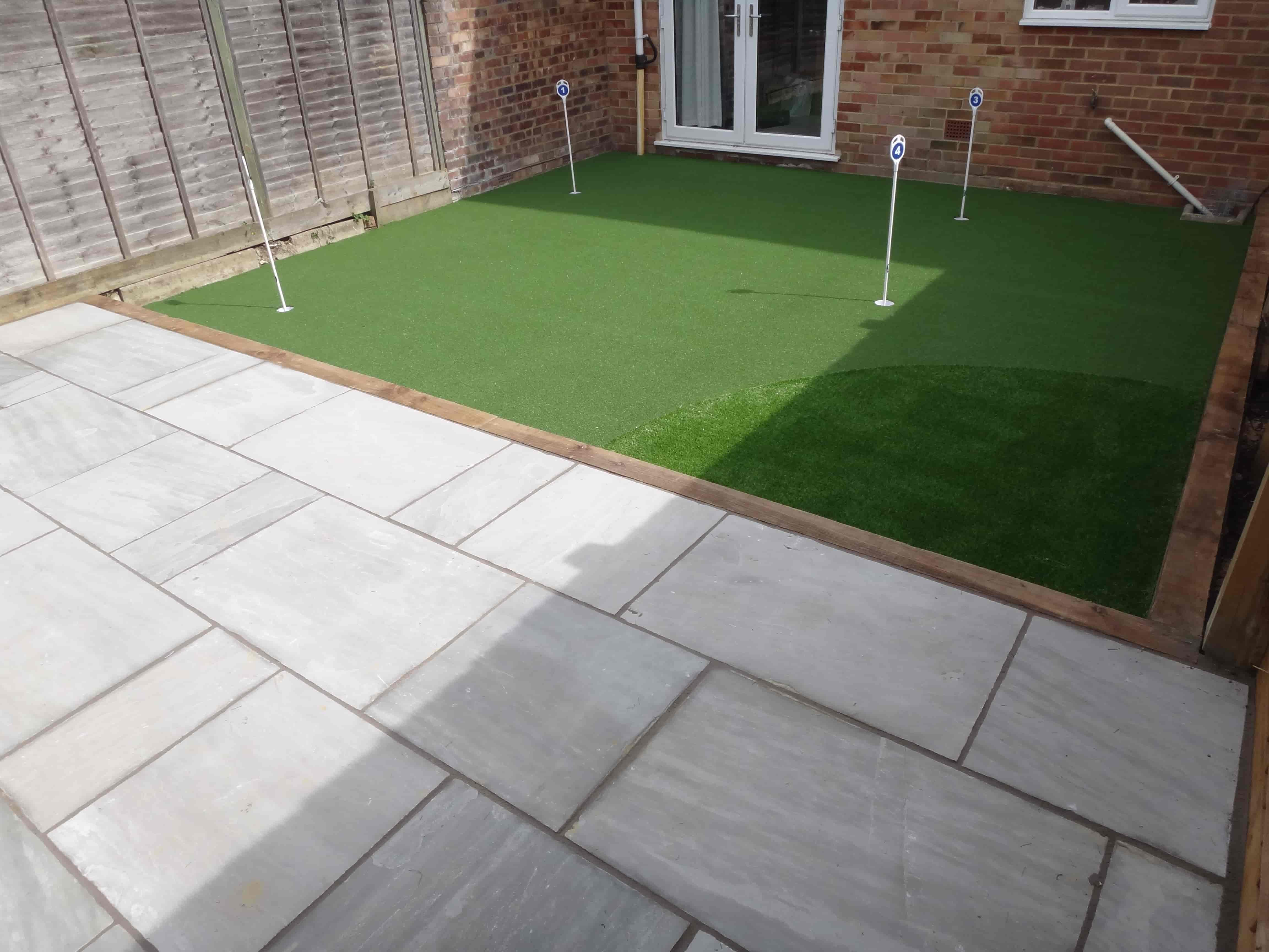 Small garden created using artificial grass by Acre Driveways